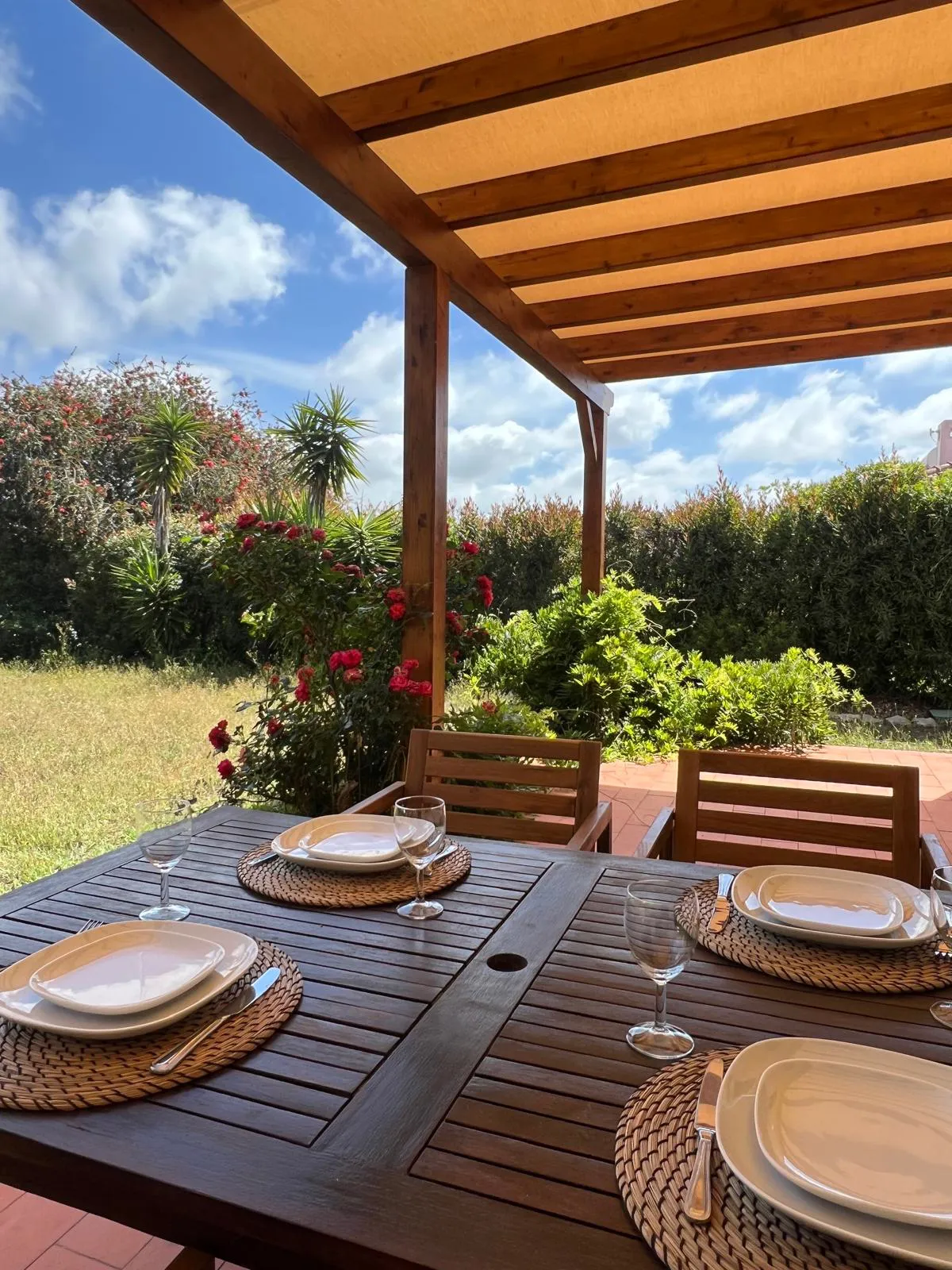 Lunch laid under the pergola, among the roses